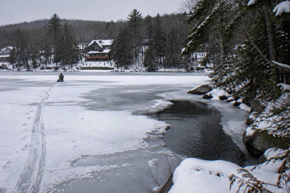Snow-covered shoreline and partially frozen cove at Deep Creek Lake in winter